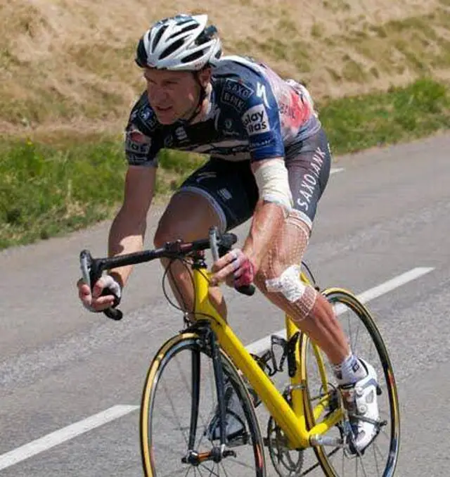 Jens Voigt borrows a child's size-bike at Tour de France