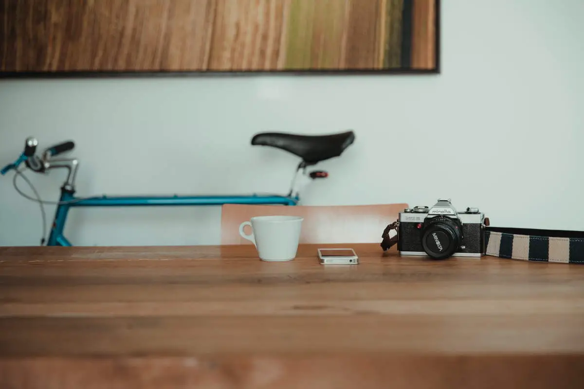 A bicycle, a camera, a smartphone, and a mug