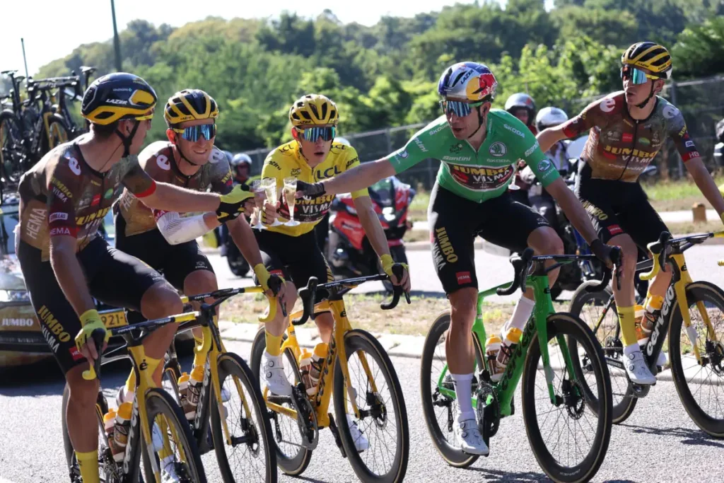 Jumbo-Visma riders share champagne during the traditional ceremonial ride into Paris on the final day of the Tour de France-a relaxed celebration before the racing resumes on the Champs-Élysées.