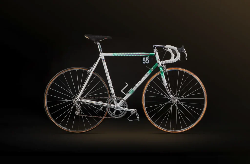 Original 1983 Colnago Master steel road bike with white-and-green paint, chrome details, and race number 55.